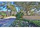 Elegant Mirasol Private Residences entrance with colorful landscaping and palm trees on a sunny day at 500 Mirasol Cir # 105, Celebration, FL 34747