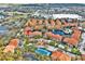 An aerial view of apartments with a lake, swimming pool, playground, and tennis court showcases community living at 6141 Metrowest E Blvd # 303, Orlando, FL 32835