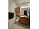 Well-lit bathroom with vanity, mirror, and functional storage at 6141 Metrowest E Blvd # 303, Orlando, FL 32835