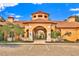 A beautiful clubhouse features a terracotta roof and an inviting archway entrance at 6141 Metrowest E Blvd # 303, Orlando, FL 32835