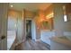 Bathroom featuring a shower, double sink vanity with modern fixtures, and neutral wall colors at 2221 The Oaks Blvd, Kissimmee, FL 34746