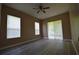 Bedroom with neutral paint, ceiling fan and wood-look floors at 2221 The Oaks Blvd, Kissimmee, FL 34746