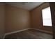 Neutral bedroom with light wood-look floors and window at 2221 The Oaks Blvd, Kissimmee, FL 34746