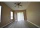 Spacious bedroom with neutral walls, wood-look floors and multiple windows at 2221 The Oaks Blvd, Kissimmee, FL 34746