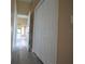 Hallway with wood-look floors and access to bathroom at 2221 The Oaks Blvd, Kissimmee, FL 34746