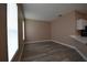 Bright living room with neutral walls, wood-look floors, and large windows providing natural light at 2221 The Oaks Blvd, Kissimmee, FL 34746