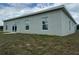 View of the back exterior of a home with a sliding glass door and windows at 5115 Old Highway 37, Lakeland, FL 33811