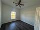 Bedroom with wood-look flooring, a ceiling fan, and a window at 5115 Old Highway 37, Lakeland, FL 33811