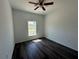 Bedroom featuring wood-look floors, a ceiling fan, and a window at 5115 Old Highway 37, Lakeland, FL 33811