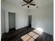 Bedroom with a ceiling fan, wood-look flooring, and plenty of natural light at 5115 Old Highway 37, Lakeland, FL 33811