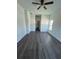 Open-concept room with wood-look flooring and modern lighting at 5115 Old Highway 37, Lakeland, FL 33811