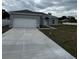 Single story home features an attached garage, neutral paint, stone accents and a concrete driveway at 5115 Old Highway 37, Lakeland, FL 33811