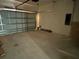 An empty garage shows a closed metal door and concrete floors at 5115 Old Highway 37, Lakeland, FL 33811