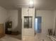 Unfinished garage with bare drywall, water heater, and utility hook-ups at 5115 Old Highway 37, Lakeland, FL 33811