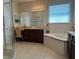 A primary bath featuring a soaking tub, tile flooring, a vanity, and a separate glass shower at 1387 Lexington Ave, Davenport, FL 33837