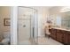 Bathroom featuring a glass-enclosed shower and vanity with granite countertops at 1387 Lexington Ave, Davenport, FL 33837