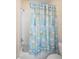 Bathtub featuring a decorative shower curtain, white tile, and silver fixtures at 1387 Lexington Ave, Davenport, FL 33837