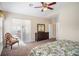 Bedroom with a ceiling fan, carpeted floors, and access to outdoor patio at 1387 Lexington Ave, Davenport, FL 33837