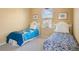 Bright bedroom featuring two twin beds, window, and decor at 1387 Lexington Ave, Davenport, FL 33837