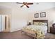 Bedroom with carpet, ceiling fan, en-suite bath and natural light from a large window at 1387 Lexington Ave, Davenport, FL 33837