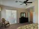 Bright main bedroom with a ceiling fan, large window, and a dark wood dresser at 1387 Lexington Ave, Davenport, FL 33837