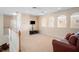 Bonus room featuring neutral colored walls, carpet, and a leather sofa near the railing at 1387 Lexington Ave, Davenport, FL 33837