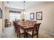 Formal dining room with wood table, seating for eight, decorative chandelier, and window at 1387 Lexington Ave, Davenport, FL 33837