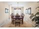 Elegant dining room with a long wooden table, seating for eight, and decorative wall art at 1387 Lexington Ave, Davenport, FL 33837