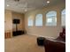 Cozy living room with neutral carpet, cut-out display shelves, and a comfortable leather sofa at 1387 Lexington Ave, Davenport, FL 33837