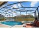 Pool and hot tub area with a view of a large pond at 1387 Lexington Ave, Davenport, FL 33837