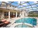 Covered pool area with hot tub, lounge furniture, and dining set at 1387 Lexington Ave, Davenport, FL 33837