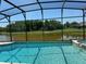 The screened-in pool offers a peaceful escape with a scenic lake view at 1387 Lexington Ave, Davenport, FL 33837