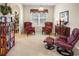 Relaxing sitting room with two plush armchairs, a bookshelf, and a reading nook at 1387 Lexington Ave, Davenport, FL 33837