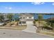 Two-story home with lake view, stone exterior, and palm trees at 507 Natural Bridge Ct, Apopka, FL 32703