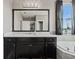 Bathroom with dark vanity, quartz countertop, and large mirror at 507 Natural Bridge Ct, Apopka, FL 32703