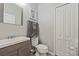 Simple bathroom with vanity, toilet, and linen closet at 507 Natural Bridge Ct, Apopka, FL 32703