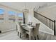 Elegant dining room with a mirrored table, gray chairs, and a modern chandelier at 507 Natural Bridge Ct, Apopka, FL 32703