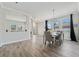 Spacious dining area with gray tile floors, a modern chandelier, and access to kitchen at 507 Natural Bridge Ct, Apopka, FL 32703