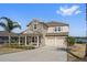 Two-story home with stone and siding, two-car garage, and lake view at 507 Natural Bridge Ct, Apopka, FL 32703