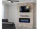 Modern electric fireplace with stone surround at 507 Natural Bridge Ct, Apopka, FL 32703