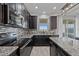 Modern kitchen with dark cabinetry, granite countertops, and stainless steel appliances at 507 Natural Bridge Ct, Apopka, FL 32703