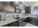 Kitchen features dark cabinetry, granite countertops, and stainless steel appliances at 507 Natural Bridge Ct, Apopka, FL 32703