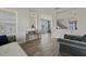 Cozy living room with gray sofa, accent chair, and wood-look tile floors at 507 Natural Bridge Ct, Apopka, FL 32703