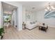 Living room with light walls, a white couch, and a rustic coffee table at 3241 Wauseon Dr, Saint Cloud, FL 34772