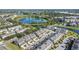 Aerial view of modern community townhomes, ponds, and lush green trees at 13712 Summerport Village Pkwy, Windermere, FL 34786