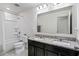 Bathroom featuring a shower-tub combo and double vanity with granite countertops at 13712 Summerport Village Pkwy, Windermere, FL 34786