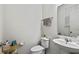 Neat half bath featuring a pedestal sink, toilet, mirror, and small decor for a clean, modern look at 13712 Summerport Village Pkwy, Windermere, FL 34786