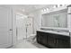 Bathroom with a glass-enclosed shower and double vanity featuring granite countertops at 13712 Summerport Village Pkwy, Windermere, FL 34786