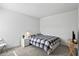 Well-lit bedroom featuring neutral paint, carpet, and a bed with a plaid comforter at 13712 Summerport Village Pkwy, Windermere, FL 34786