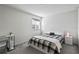 Bedroom with a plaid comforter, desk and good natural light for a cozy and functional space at 13712 Summerport Village Pkwy, Windermere, FL 34786